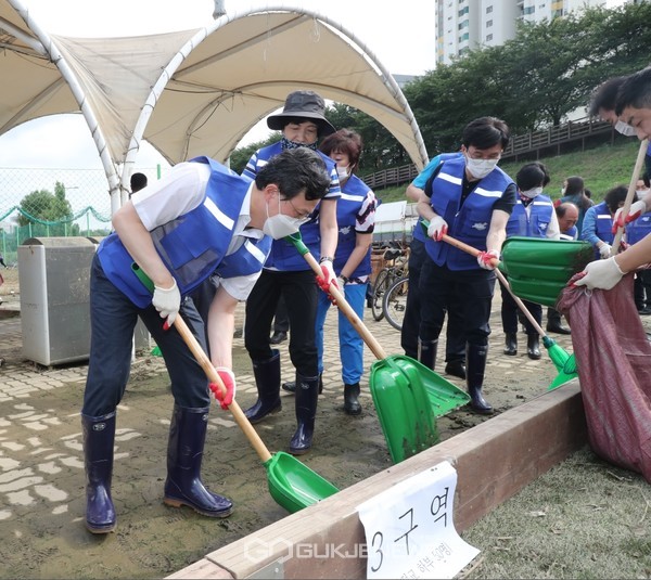 채현일 영등포구청장(왼쪽)과 김영주, 김민석 국회의원이 함께 안양천 일대에 쌓인 진흙과 퇴적물 청소를 하고 있다.