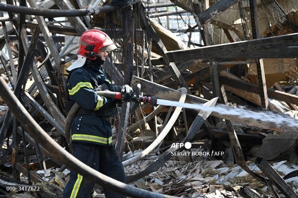 2024년 5월 26일 러시아 공습으로 파괴된 우크라이나 하르키우의 대형 상점에서 물을 뿌리고 있는 소방대원. 사진제공/AFP통신
