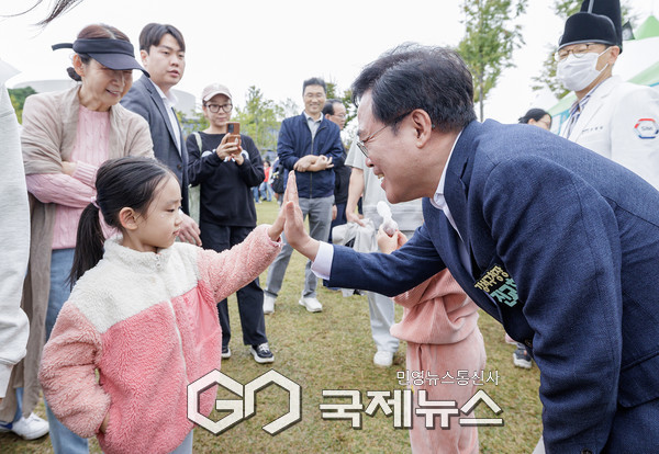 진교훈 서울 강서구청장(오른쪽)이 18일(토) 서울식물원과 마곡광장 일대서 열린 ‘제23회 허준축제’에서 축제장을 찾은 한 아이와 손인사를 하고 있다. [사진제공=강서구청]