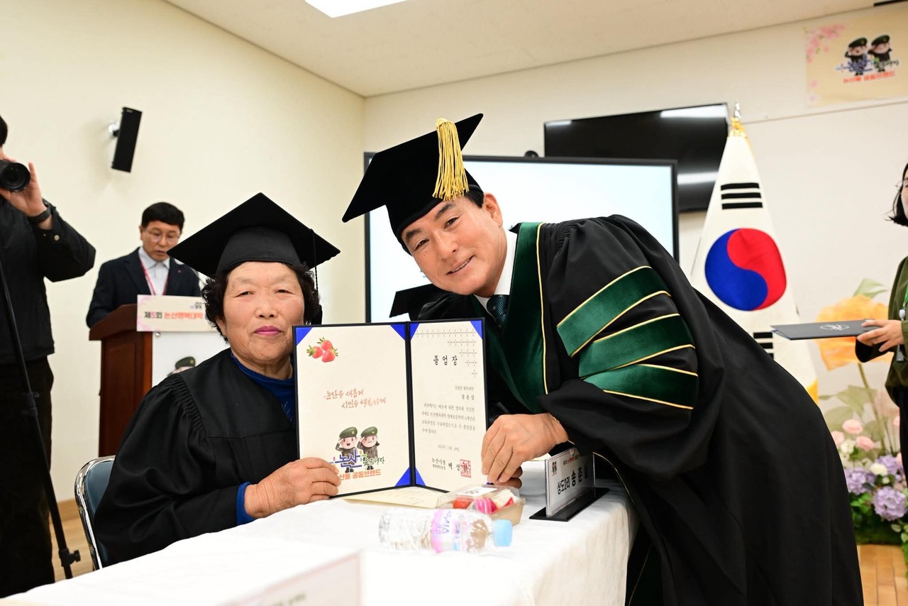 당당한 졸업장을 받은 행복대학 졸업생 어머님을 축하하는 백성현 시장 (사진/본인 페이스북)
